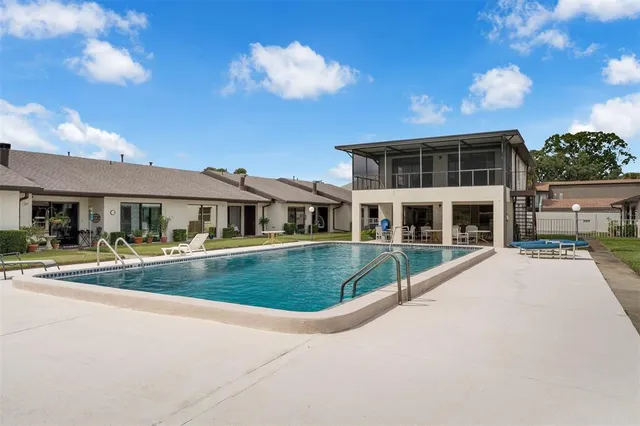 an aerial view of a house with a garden and lake view