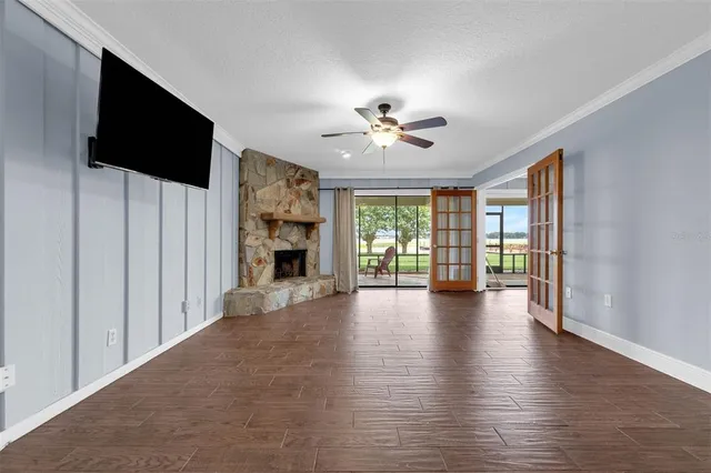 a view of an empty room with a fireplace and a window