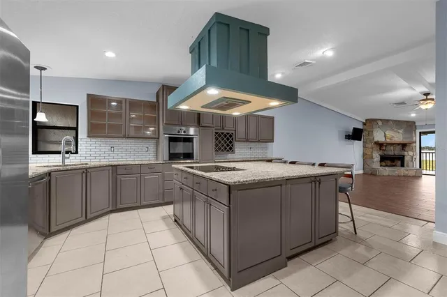 a kitchen with stainless steel appliances granite countertop a sink and cabinets