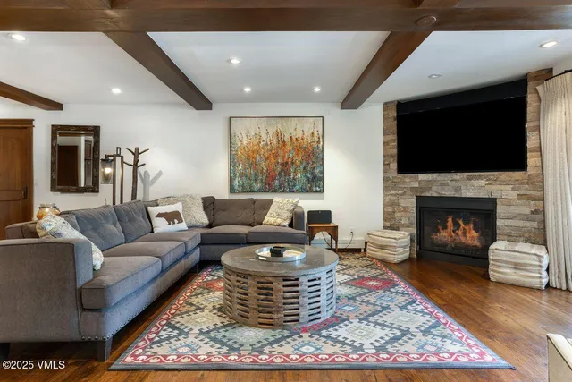 a living room with furniture a flat screen tv and a fireplace