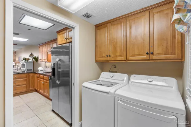 a kitchen with a refrigerator and washer