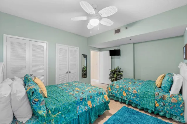 a bedroom with bed and a chandelier