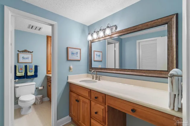 a bathroom with a toilet a sink and a mirror