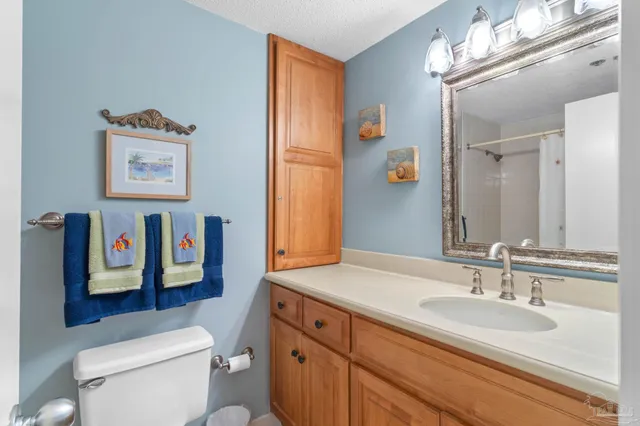 a bathroom with a toilet a sink and a mirror