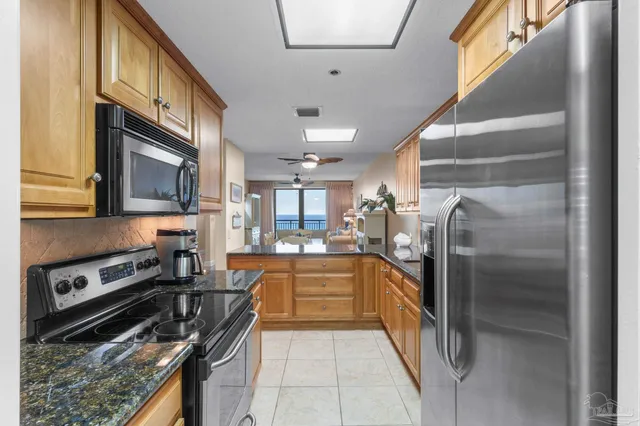 a kitchen with stainless steel appliances granite countertop a refrigerator and a stove