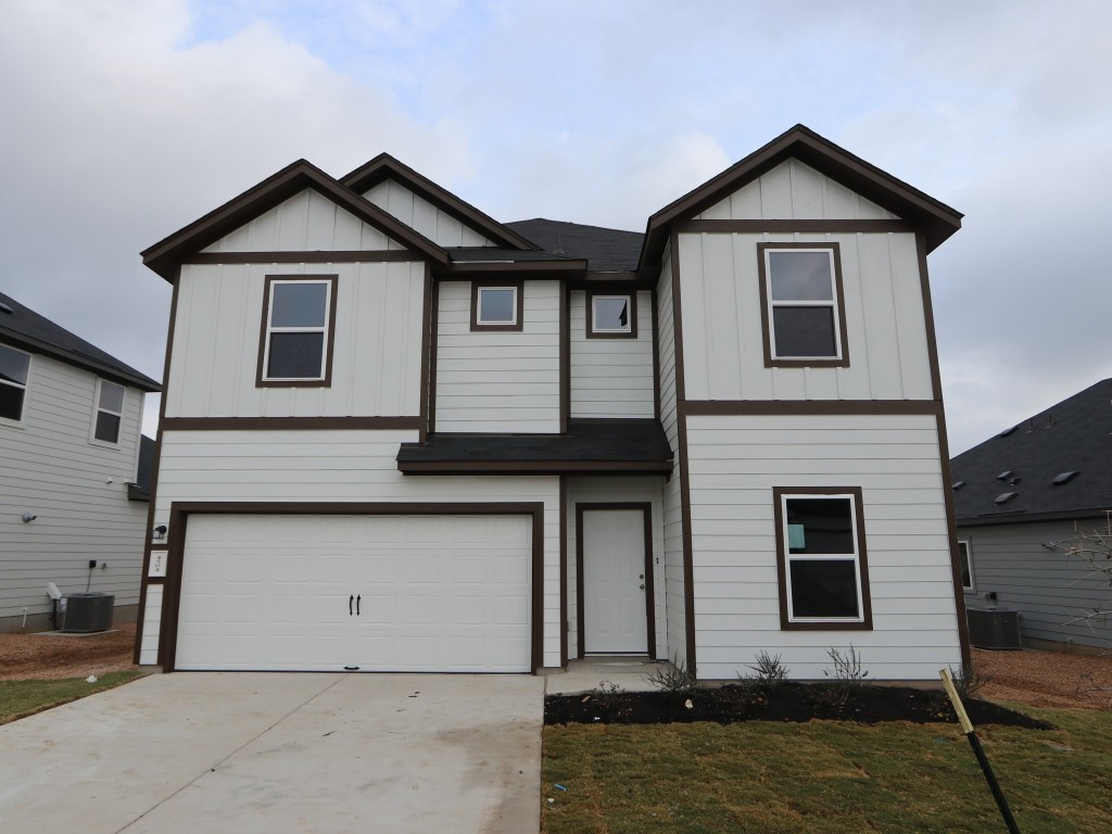 a front view of a house with garage