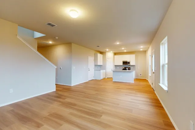 a view of kitchen with kitchen island sink and refrigerator