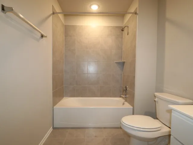 a bathroom with a bathtub and a toilet