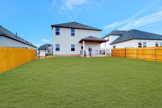 a view of a backyard with a garden and deck