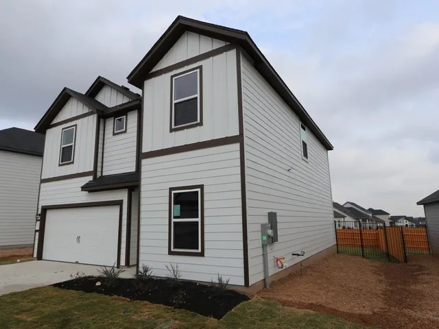 a view of a house with yard and garage