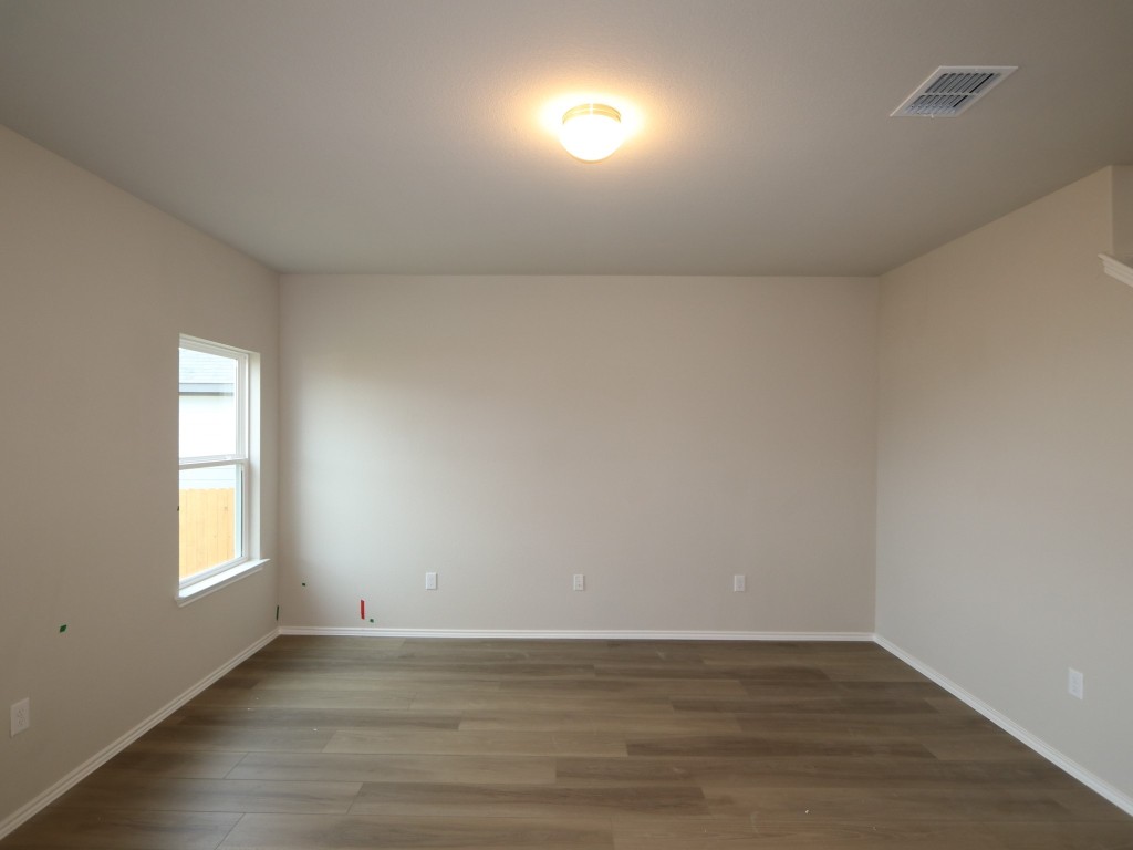 4504 Beacon Bay Drive Austin, TX 78747 - Photo 6 of 31 an empty room with wooden floor and windows