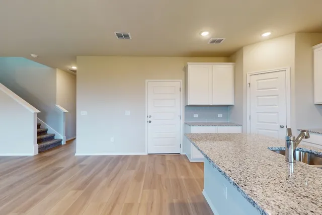 a kitchen with granite countertop a stove and a sink