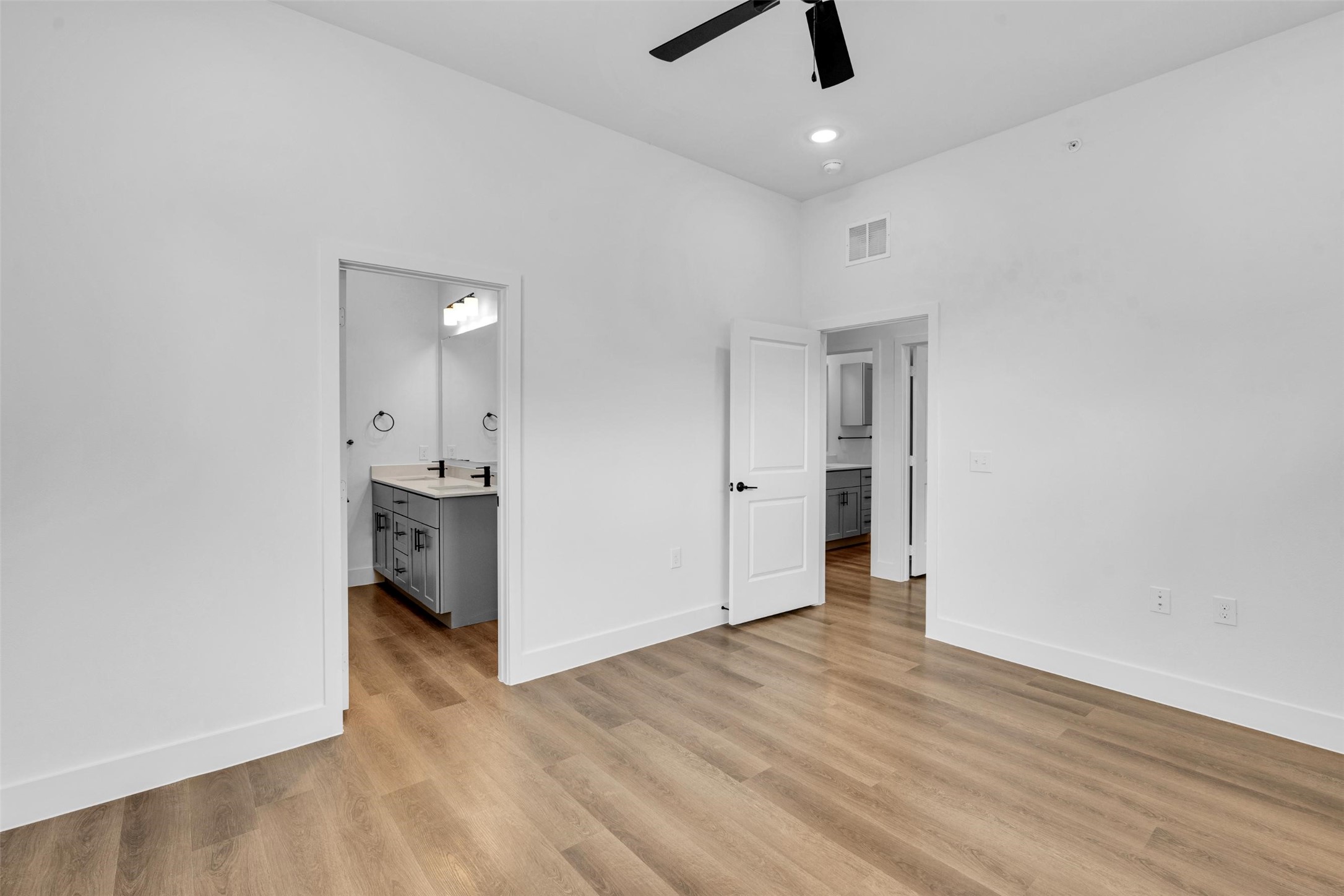 2028-703 Boykin Way Garland, TX 75040 - Photo 11 of 31 wooden floor in an empty room with a kitchen