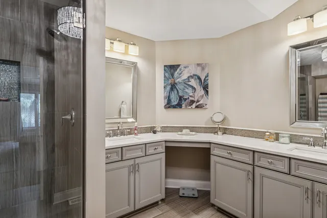 a view with cabinets a sink and a painting on the wall