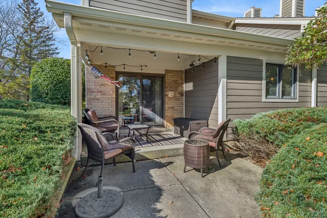 a view of a patio with table and chairs and potted plants