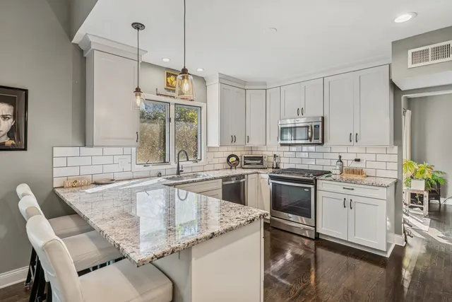a kitchen with appliances cabinets and a sink
