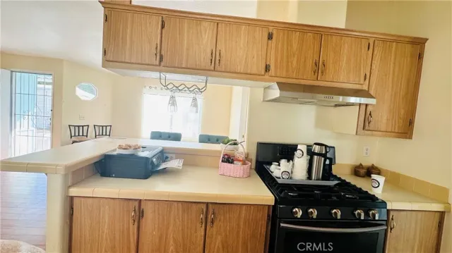 a kitchen with a stove and a refrigerator