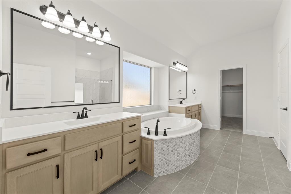 610 Tenor Drive Forney, TX 75126 - Photo 12 of 30 a spacious bathroom with a double vanity sink mirror and bathtub