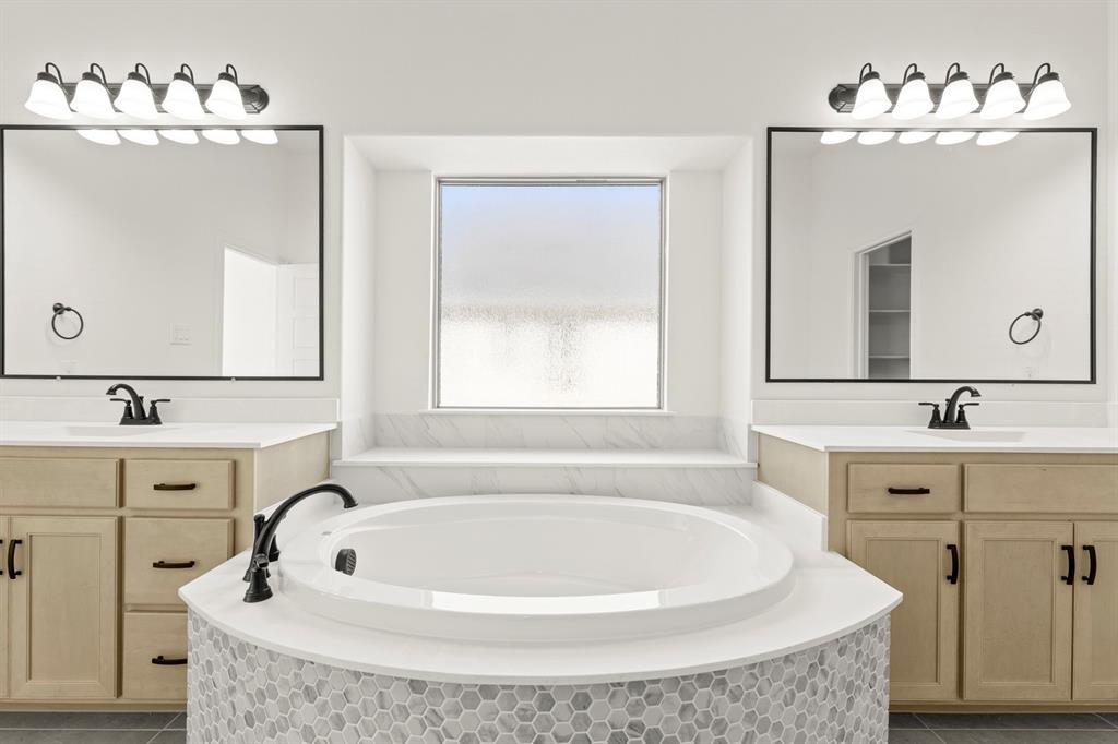 610 Tenor Drive Forney, TX 75126 - Photo 13 of 30 a bathroom with a tub sink and mirror