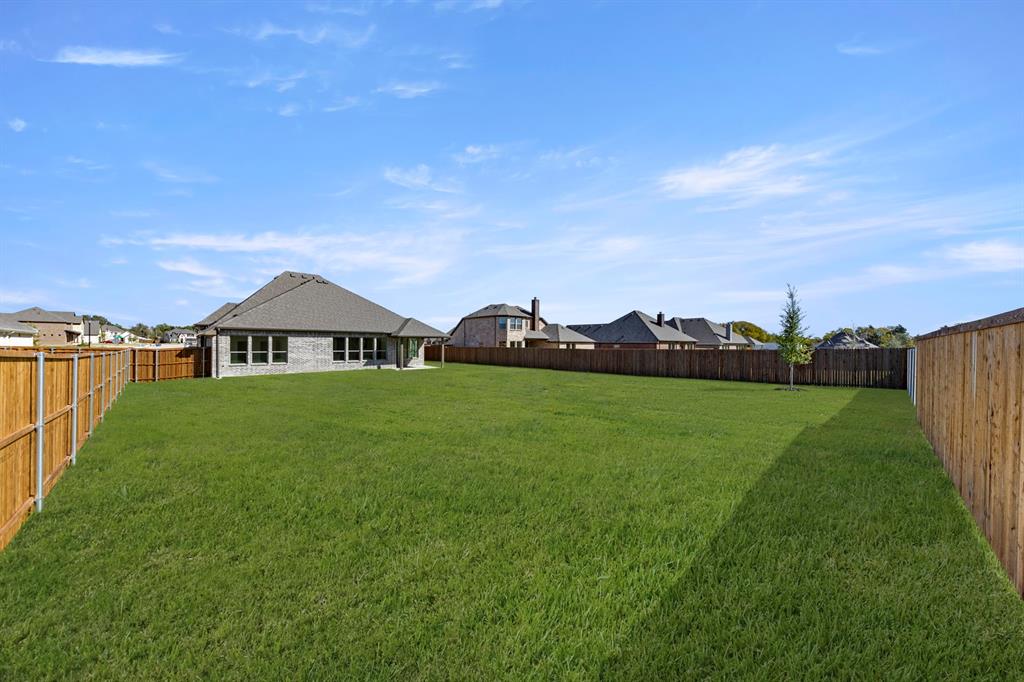 610 Tenor Drive Forney, TX 75126 - Photo 27 of 30 a front view of a house with garden