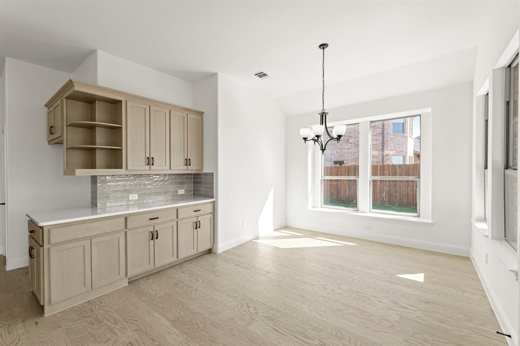 610 Tenor Drive Forney, TX 75126 - Photo 6 of 30 a bathroom with a granite countertop sink a bathtub and shower