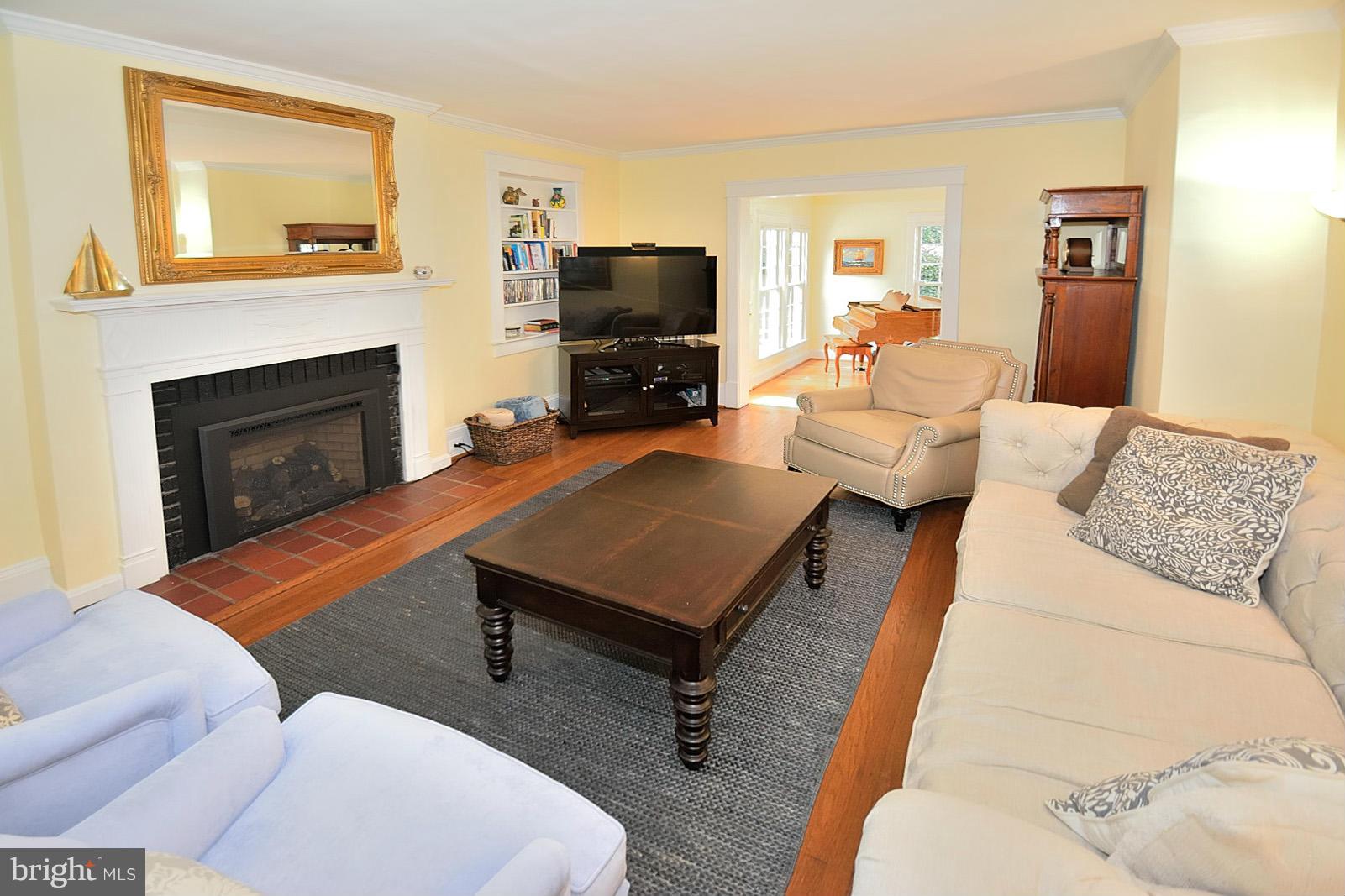 404 Russell Road Alexandria, VA 22301 - Photo 8 of 29 a living room with furniture a flat screen tv and a fireplace