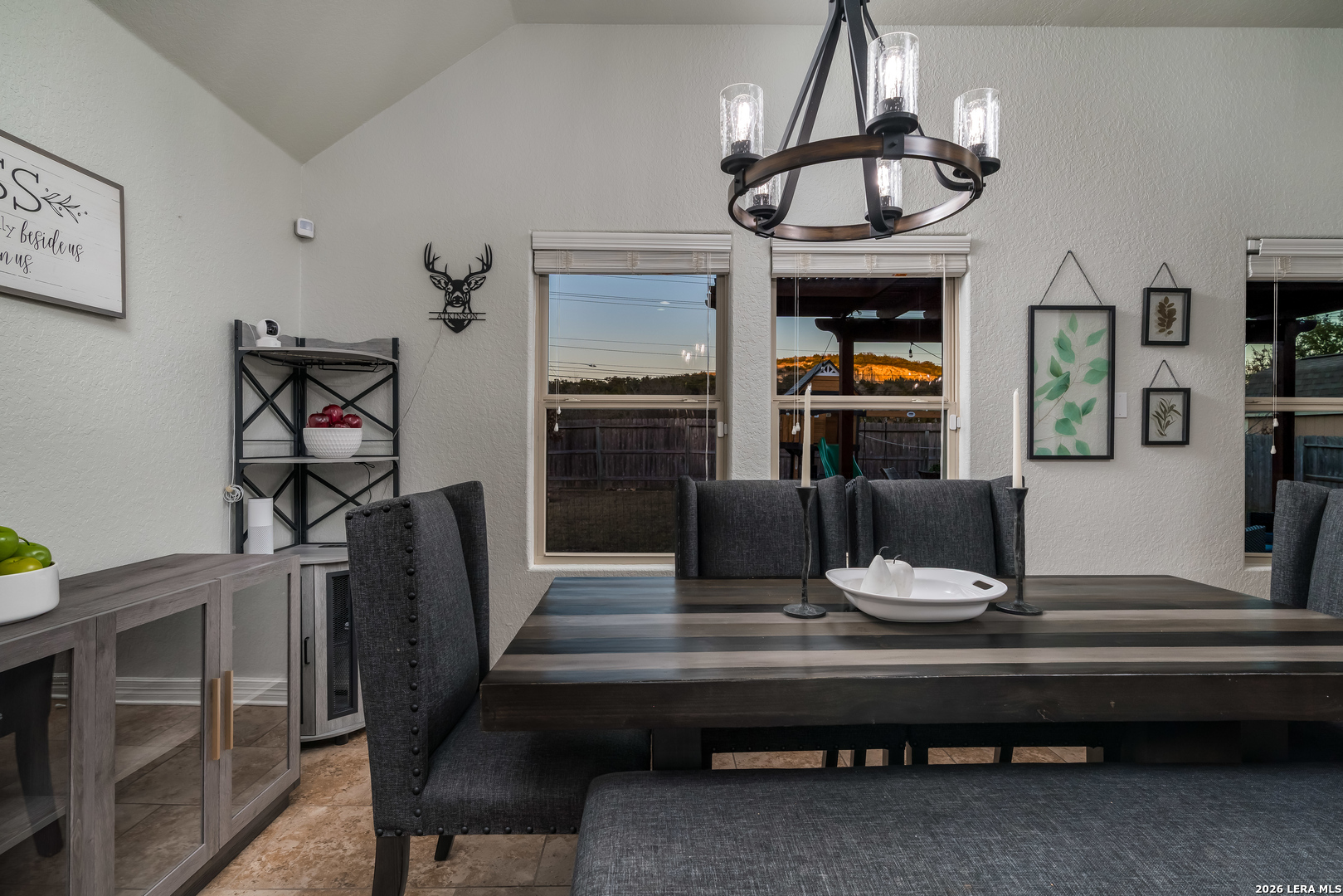 11331 Massive Mount Helotes, TX 78023 - Photo 15 of 43 a living room with furniture a table kitchen view and a chandelier