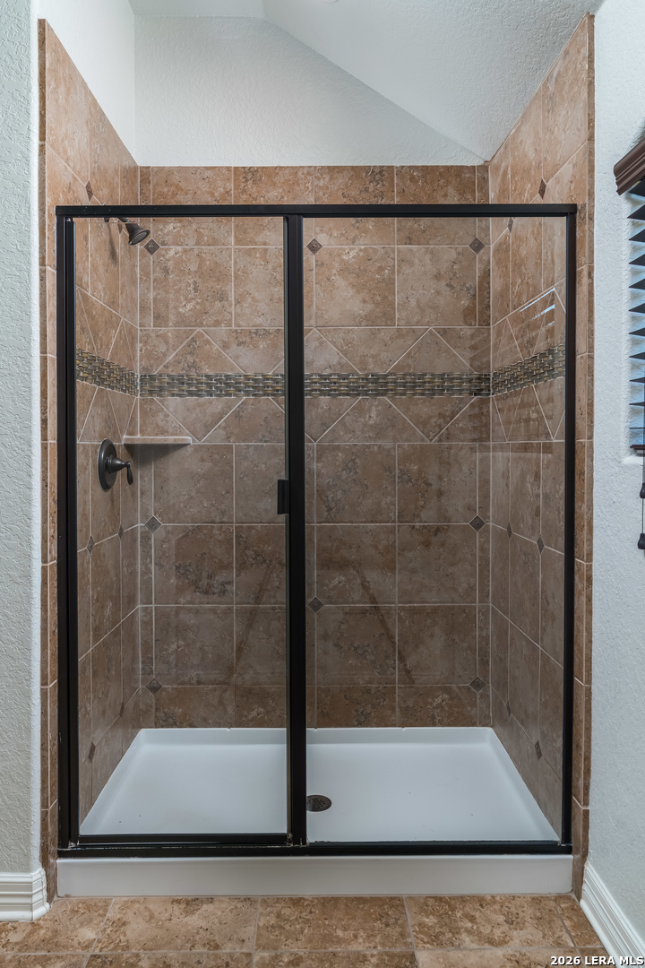 11331 Massive Mount Helotes, TX 78023 - Photo 21 of 43 a bathroom with a glass shower door