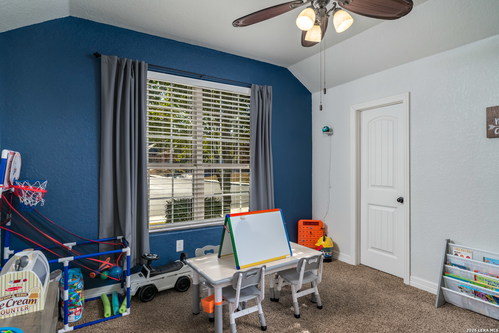 11331 Massive Mount Helotes, TX 78023 - Photo 26 of 43 a living room with furniture a chandelier and a window