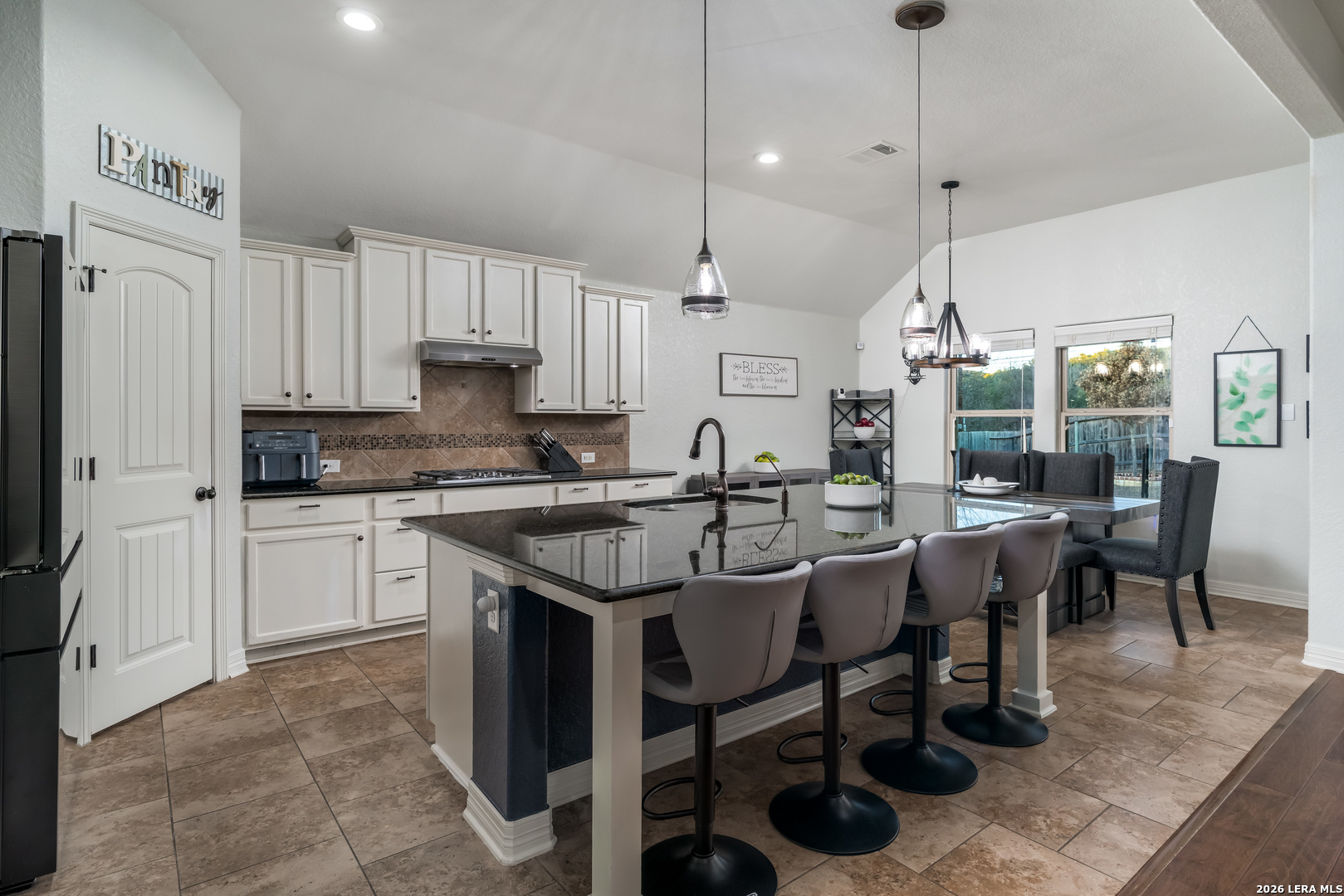 11331 Massive Mount Helotes, TX 78023 - Photo 9 of 43 a kitchen with stainless steel appliances granite countertop a table chairs sink and cabinets