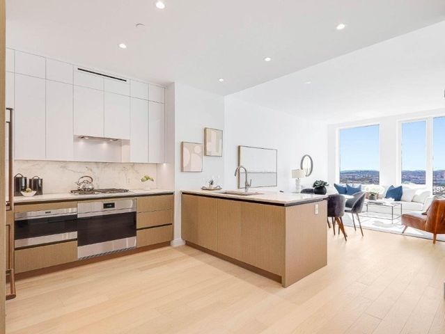 a kitchen with stainless steel appliances granite countertop a stove and a sink