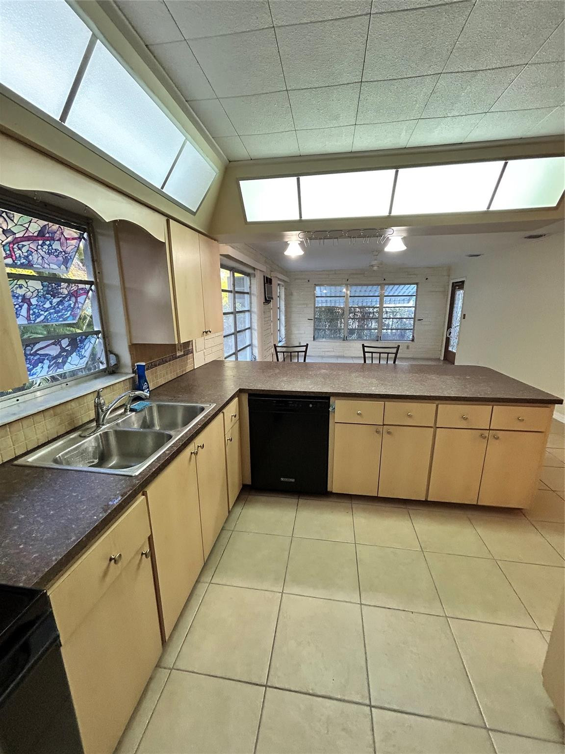 244 Southwest 3rd Place Dania Beach, FL 33004 - Photo 12 of 42 a large kitchen with a sink and cabinets