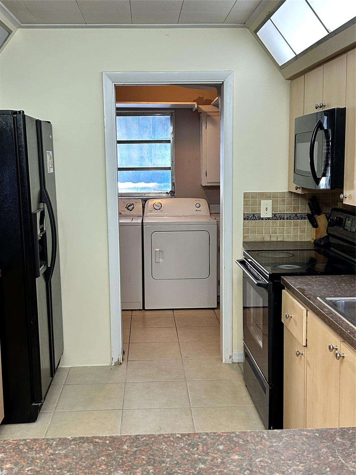 244 Southwest 3rd Place Dania Beach, FL 33004 - Photo 15 of 42 a kitchen with a stove and a refrigerator