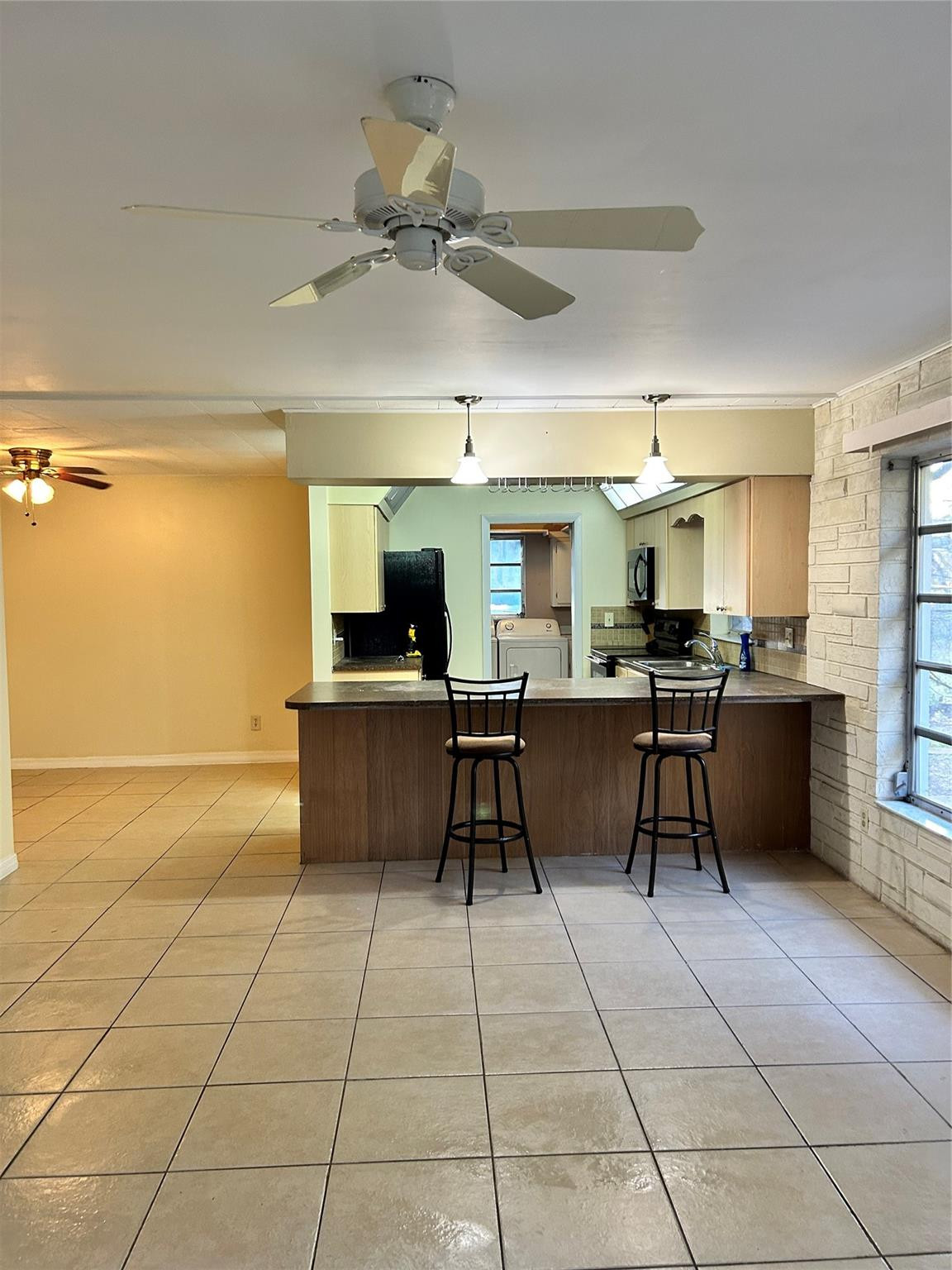 244 Southwest 3rd Place Dania Beach, FL 33004 - Photo 19 of 42 a kitchen with stainless steel appliances kitchen island granite countertop a sink and cabinets