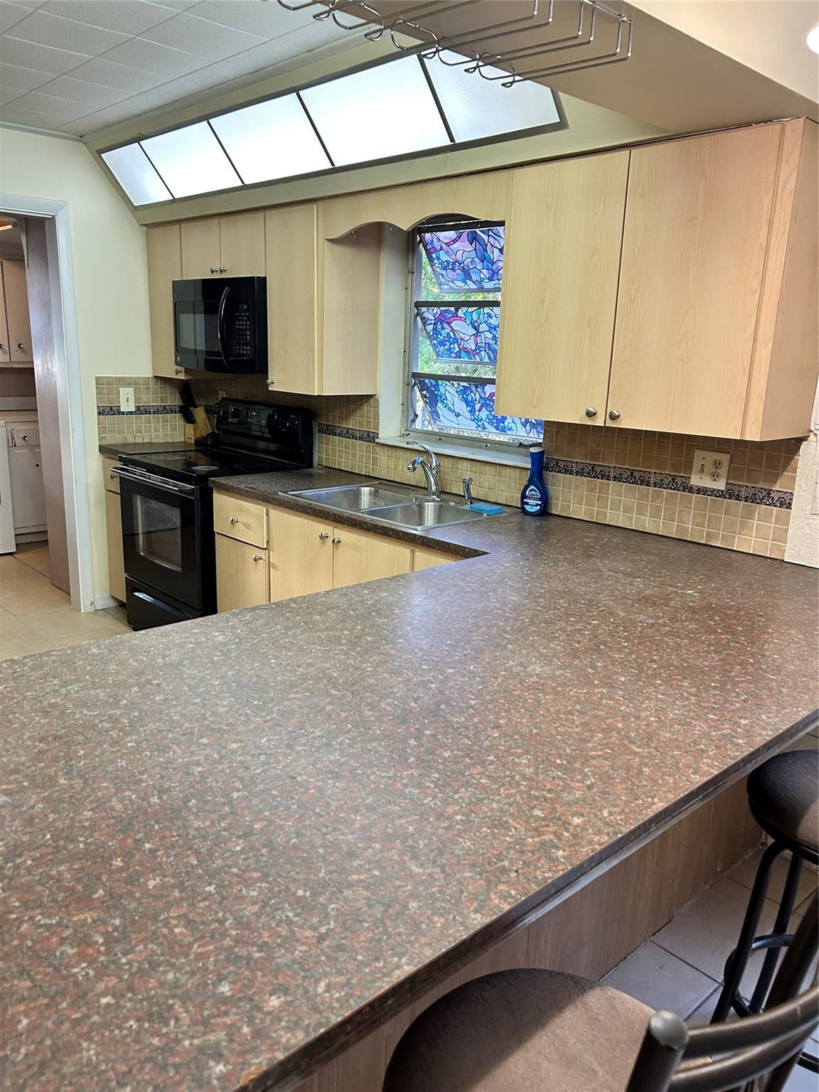 244 Southwest 3rd Place Dania Beach, FL 33004 - Photo 20 of 42 a kitchen with stainless steel appliances a sink a stove and a microwave