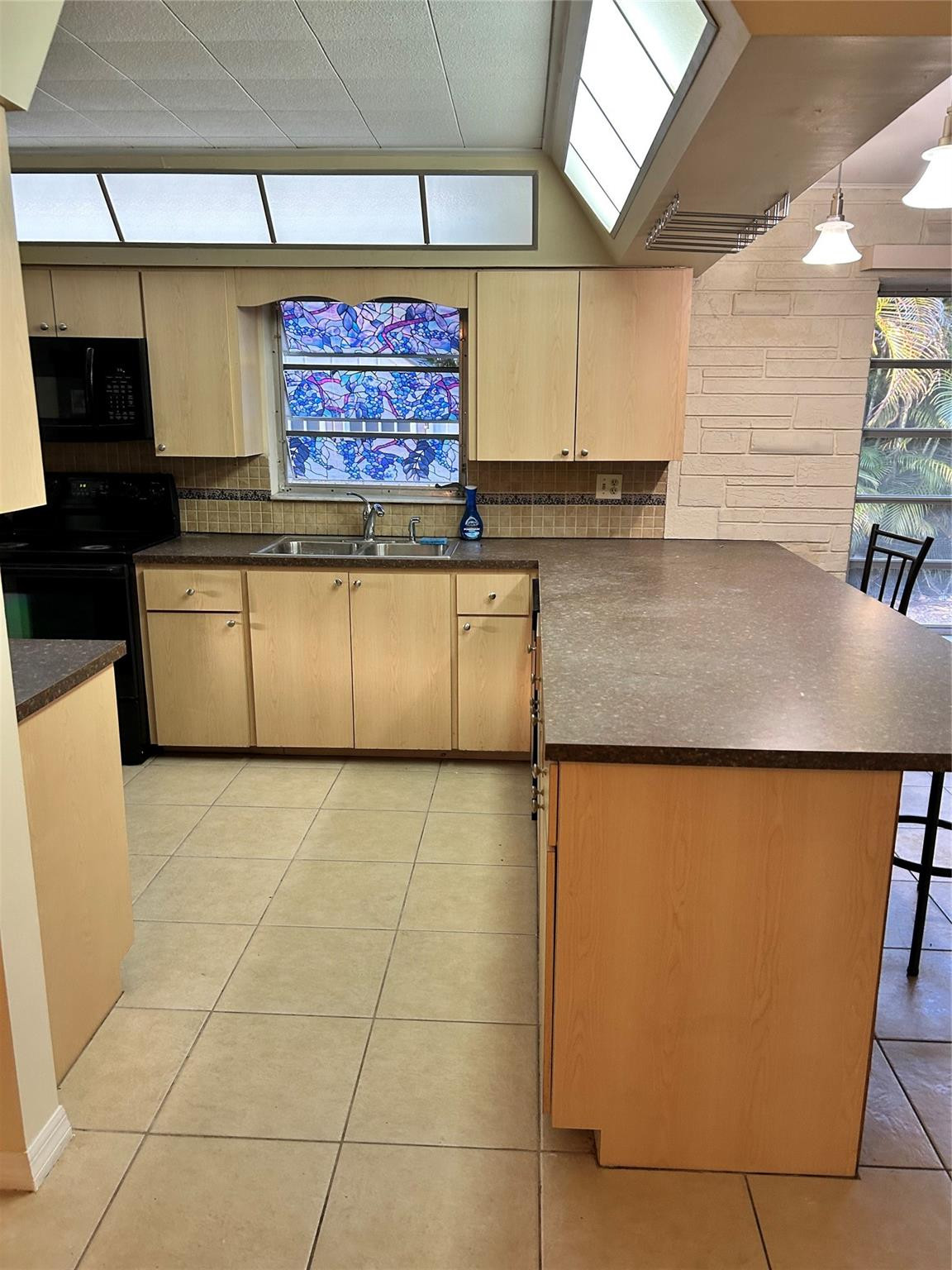 244 Southwest 3rd Place Dania Beach, FL 33004 - Photo 25 of 42 a kitchen with stainless steel appliances granite countertop a sink and a stove