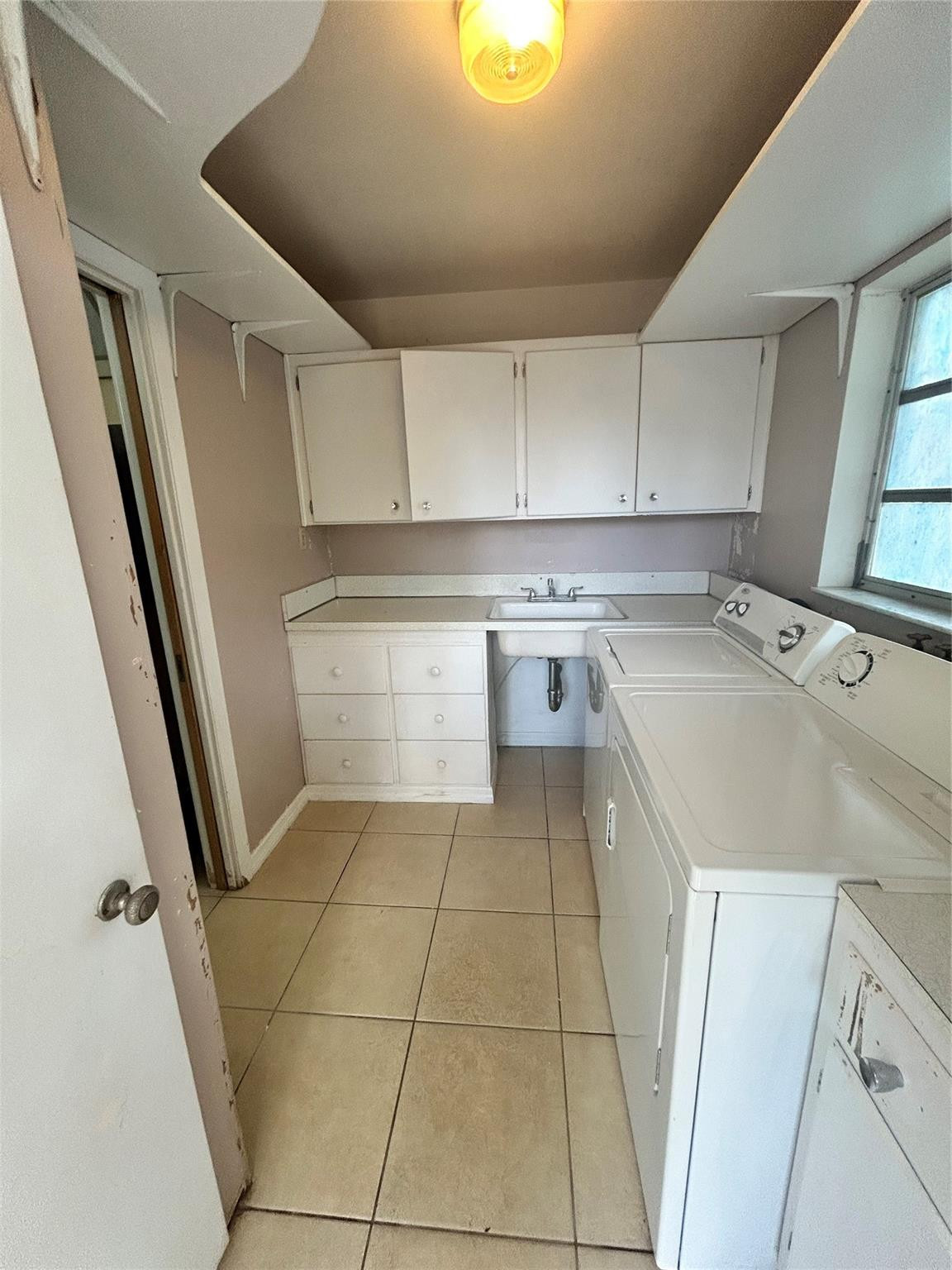 244 Southwest 3rd Place Dania Beach, FL 33004 - Photo 27 of 42 a kitchen with a sink a stove top oven and cabinetry