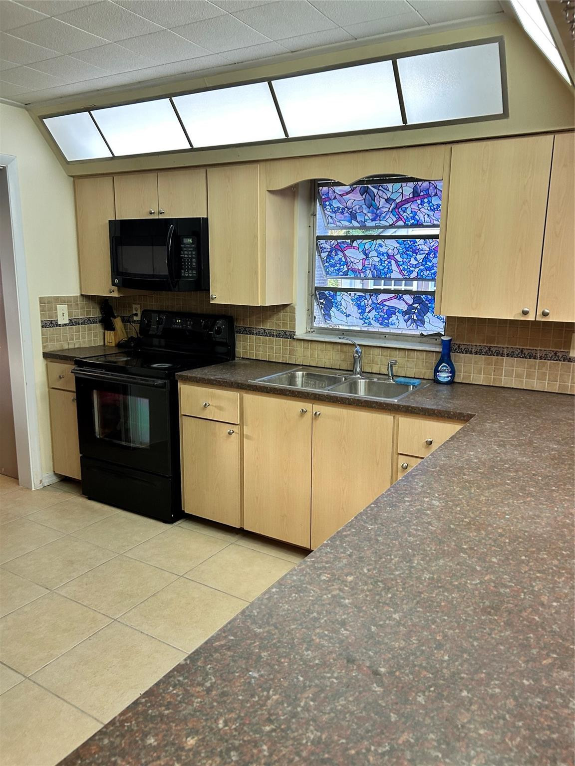 244 Southwest 3rd Place Dania Beach, FL 33004 - Photo 5 of 42 a view of a kitchen with stainless steel appliances granite countertop a stove and a sink