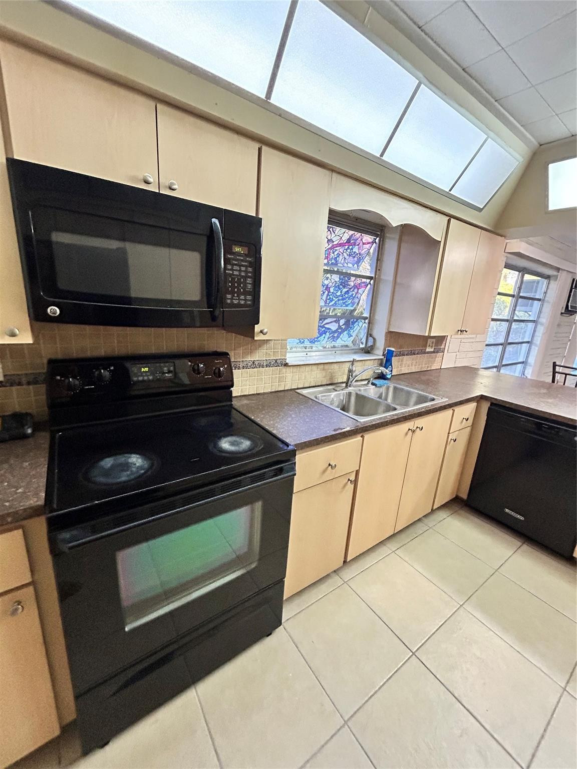 244 Southwest 3rd Place Dania Beach, FL 33004 - Photo 10 of 42 a kitchen with a stove and a microwave