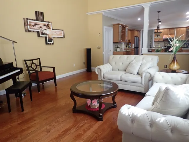 a kitchen with stainless steel appliances granite countertop sink stove refrigerator dining table and chairs