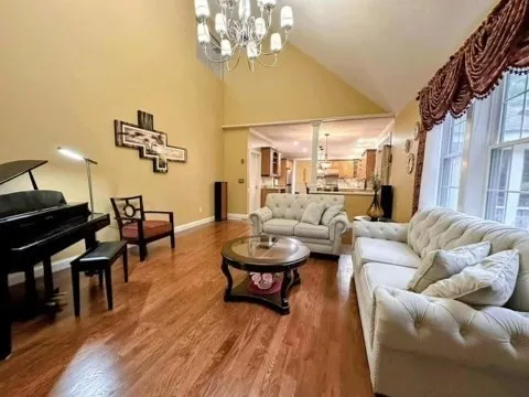a living room with furniture and a wooden floor