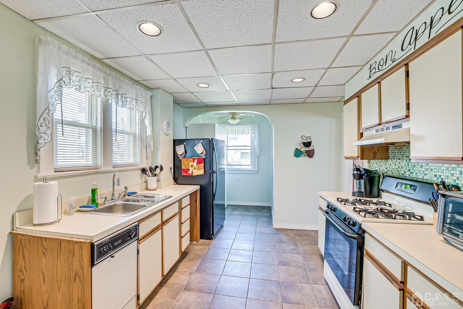 1690 Porter Road Union, NJ 07083 - Photo 13 of 28 a kitchen that has a sink a stove top oven a counter space and a window