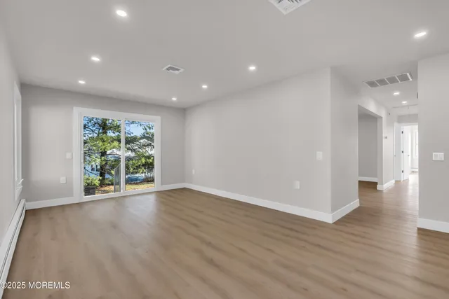 a view of an empty room with a kitchen