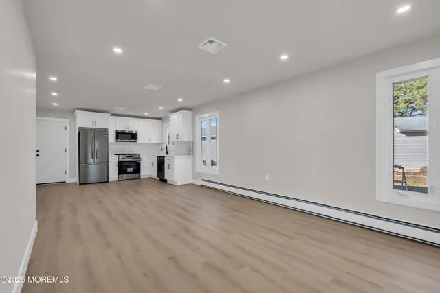 a view of kitchen with stainless steel appliances refrigerator and stove