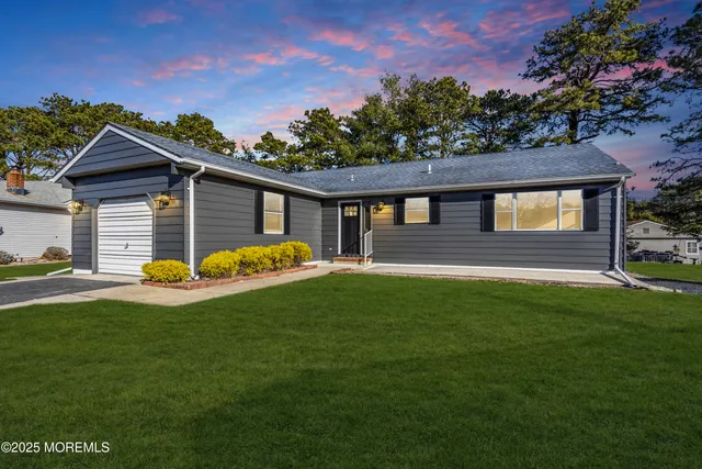 a view of a house with a backyard porch and sitting area