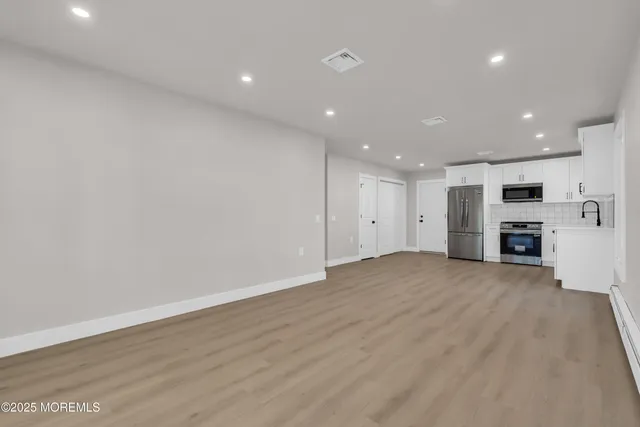 a kitchen with stainless steel appliances a refrigerator stove microwave and cabinets