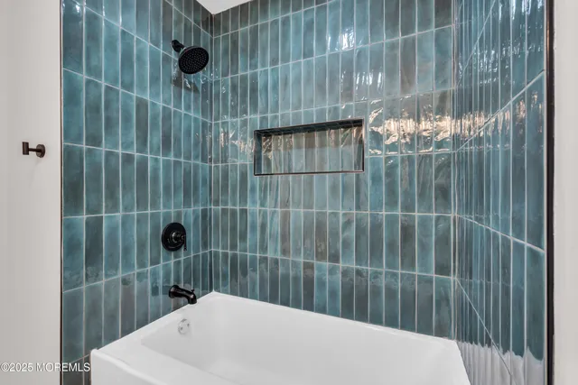 an empty room with ceiling fan and window