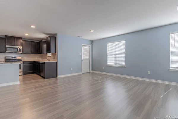 a view of kitchen with wooden floor and electronic appliances