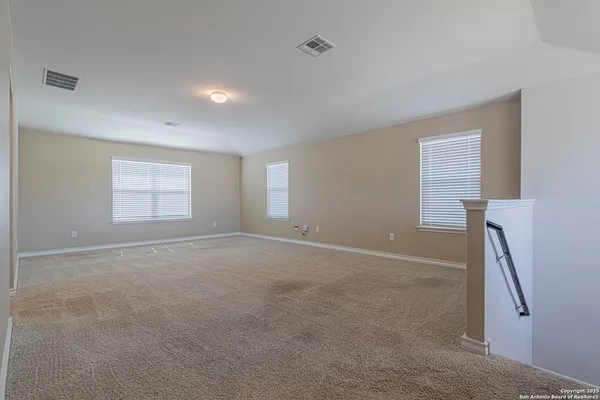 an empty room with windows and closet