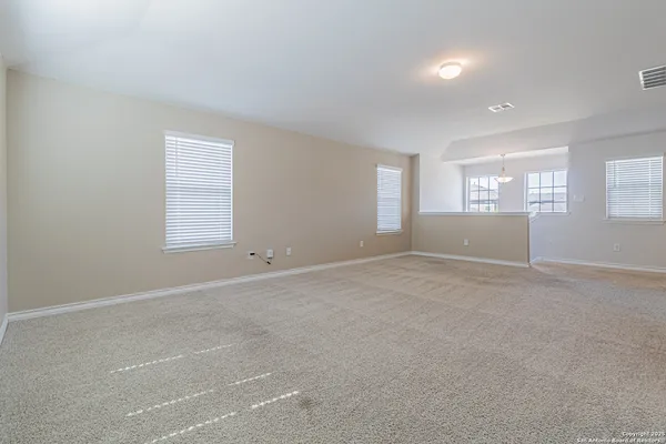 an empty room with windows and closet